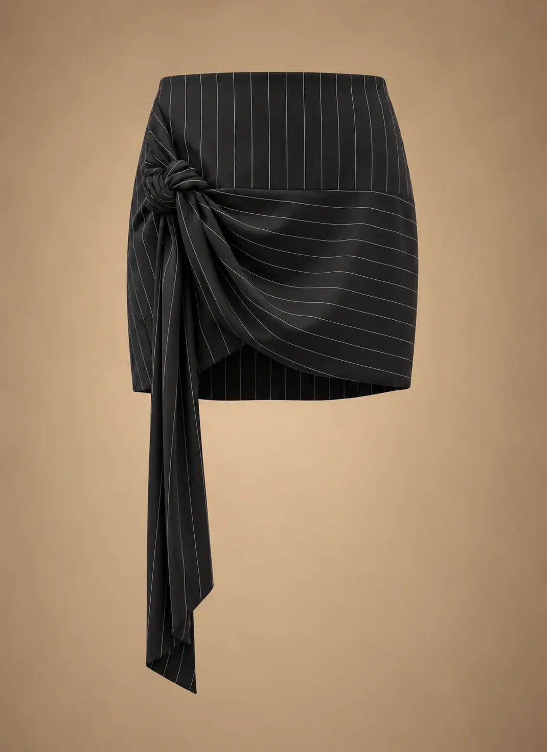 Black women's pinstripe mini skirt featuring an asymmetrical draped wrap design, side knot and long hanging fabric sash