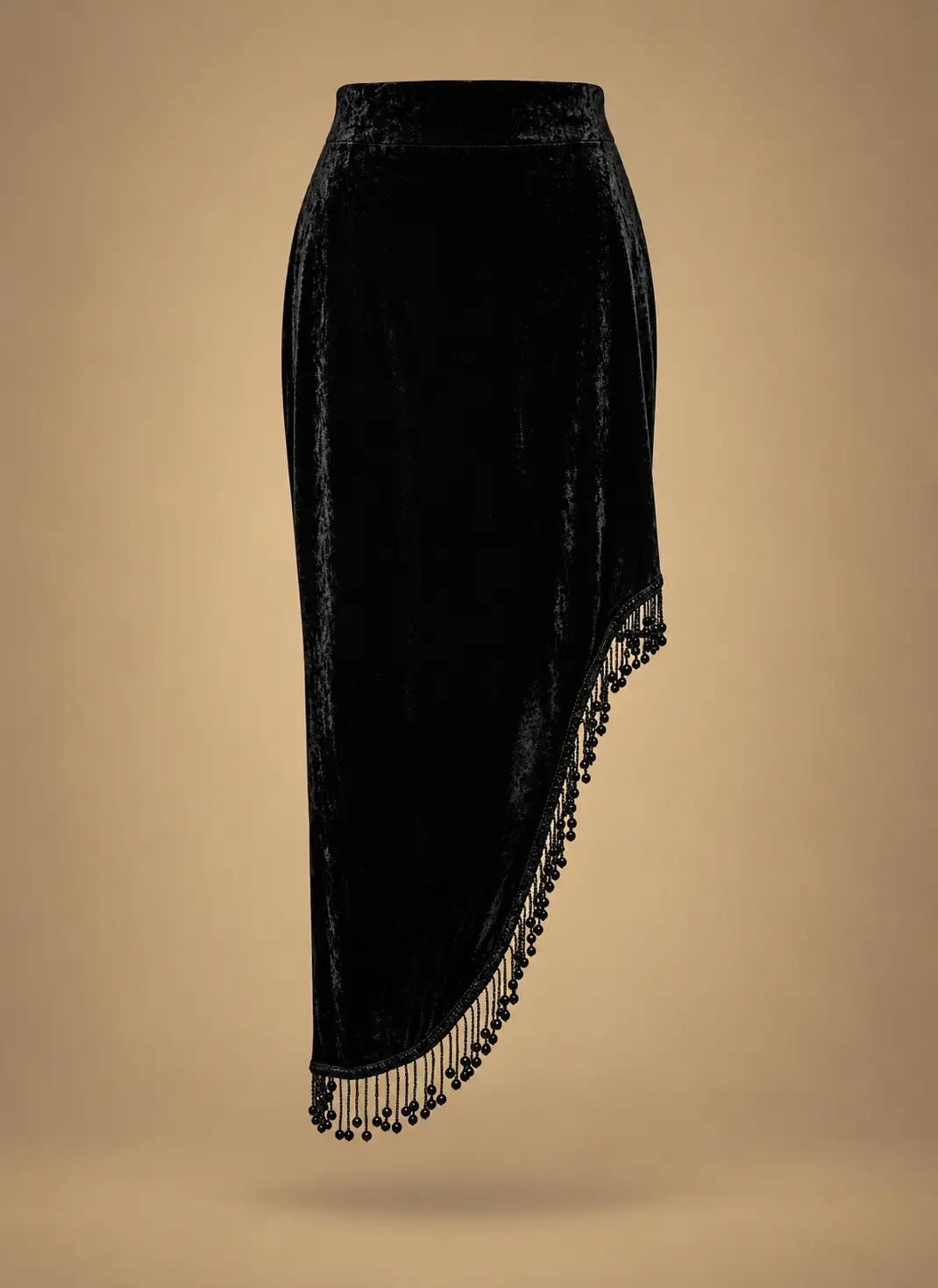 Black velvet women's midi skirt featuring a fitted waistband, asymmetrical curved hem and decorative hanging bead fringe